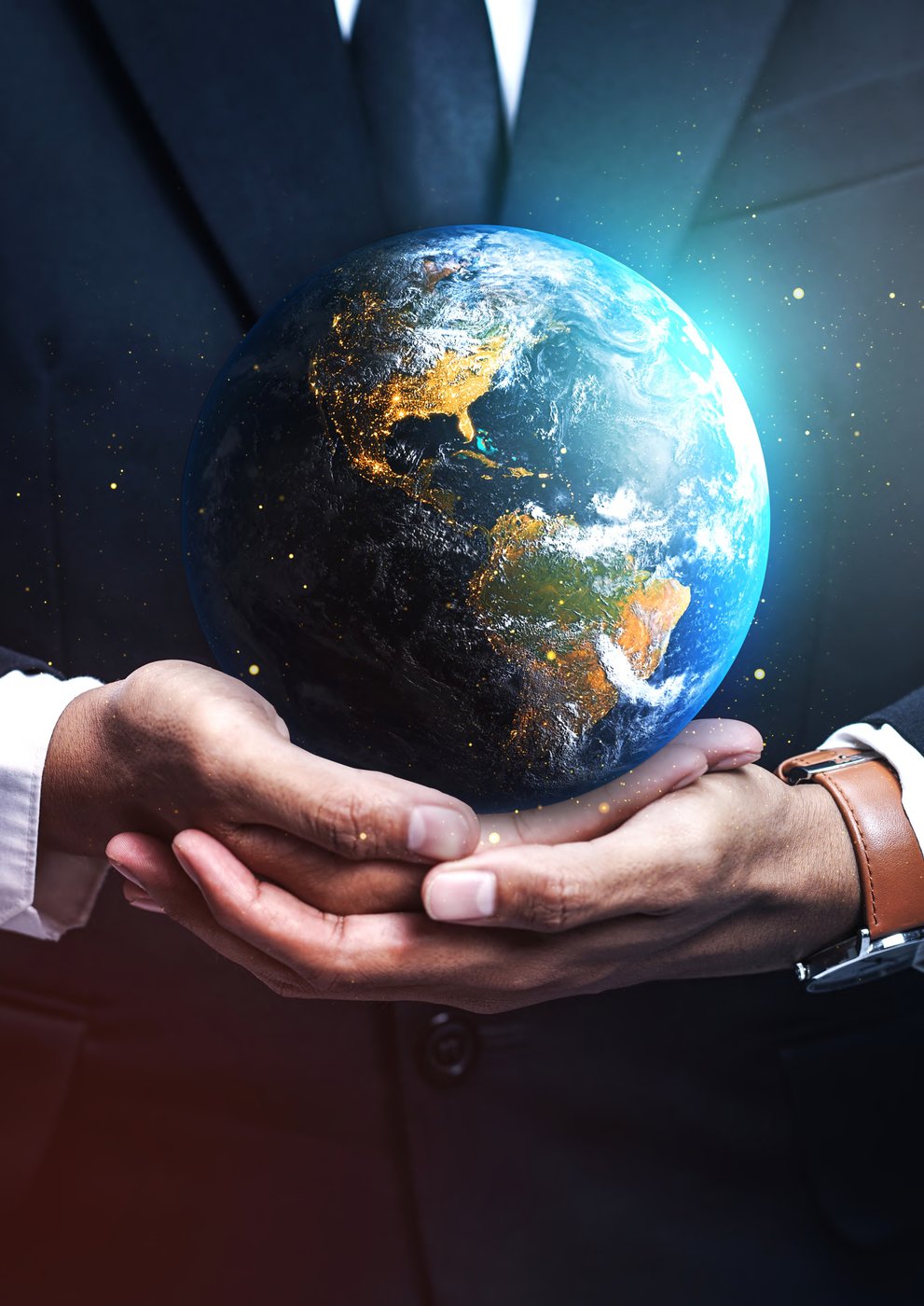 A globe held in human hands — symbol of PIMC's global mission